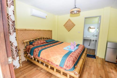 a bedroom with a bed with a cat sitting on it at Sairee View Resort in Koh Tao