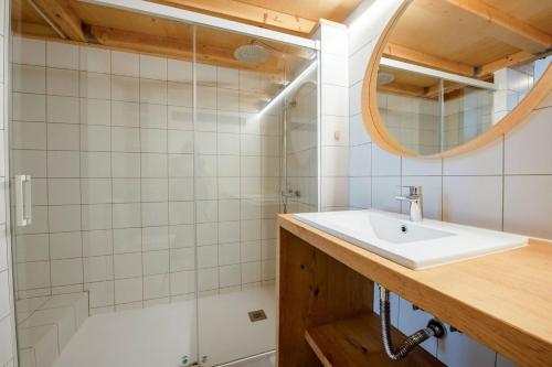 a bathroom with a sink and a shower at Suances Surf Beach in Suances