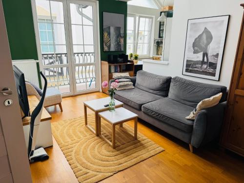a living room with a couch and a table at Mandala Koszalin in Koszalin