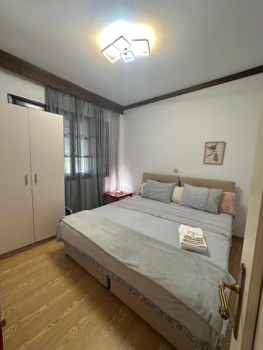 a bedroom with a large bed and a window at Greek Mansion in Nea Moudania