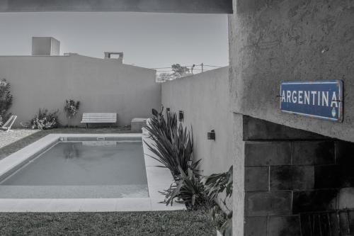 a sign on a building next to a swimming pool at Chito House in Buenos Aires