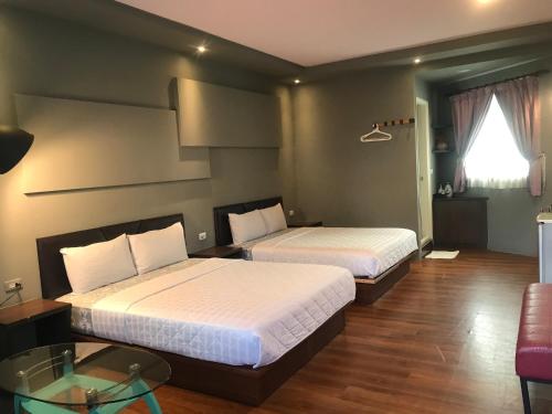 Postel nebo postele na pokoji v ubytování 墾丁貝殼灣旅店