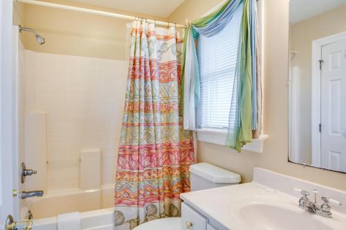 a bathroom with a shower curtain and a sink at Milky Way in Nags Head