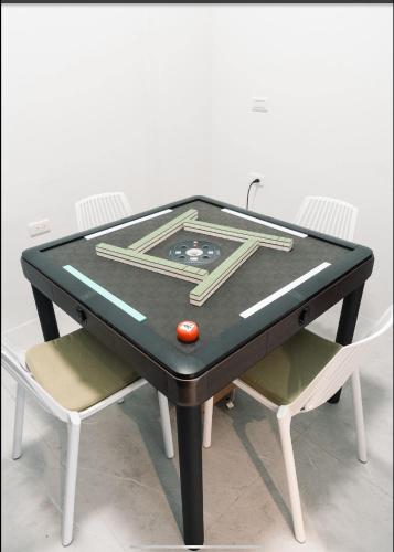 a ping pong table with two chairs and a ball on it at 四季-芒種 Mangzhong in Wujie