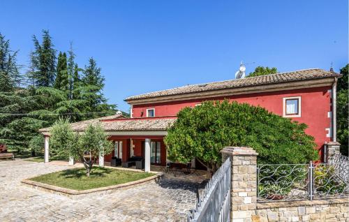 a red house with a fence in front of it at Gorgeous Home In Loc Avenale, Cingoli in Avenale