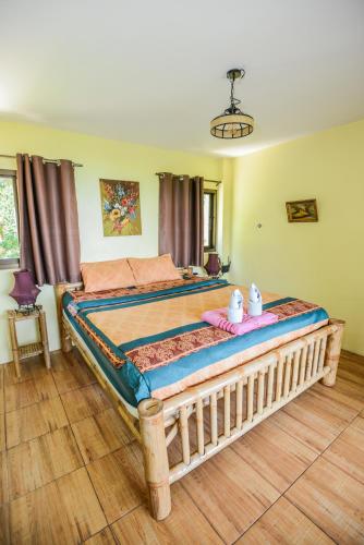 a bedroom with a large bed with two stuffed animals on it at Sairee View Resort in Koh Tao