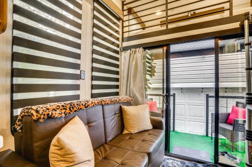 a living room with a couch and a window at 10 Mi to Leesylvania and River Sleek Mobile Home in Woodbridge