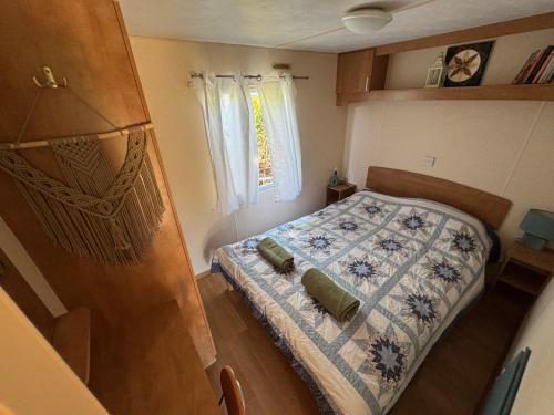 mała sypialnia z łóżkiem i oknem w obiekcie Mandala Mielno Camping w mieście Mielno