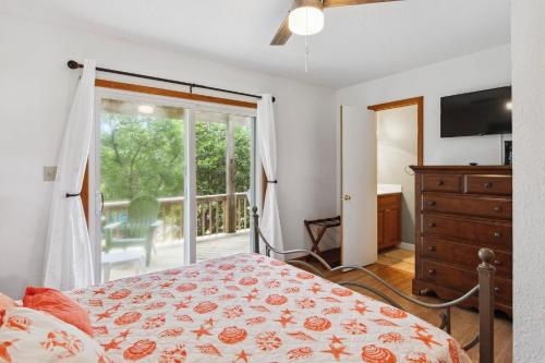 a bedroom with a bed and a large window at A Change In Attitude in Duck