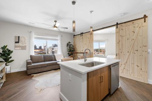 a kitchen with a sink and a sliding barn door at The Diamond Suite The Gulch in Nashville