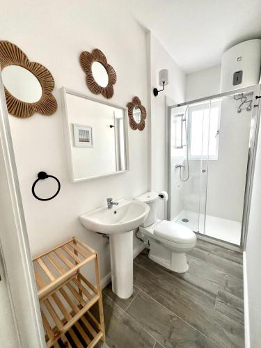 a bathroom with a toilet and a sink and a shower at Stylish Boutique House - Turquoise - Outdoor Yard & Adjoining Cafeteria - Very Central! Near Valletta - Non-Sharing & Quiet in Hamrun