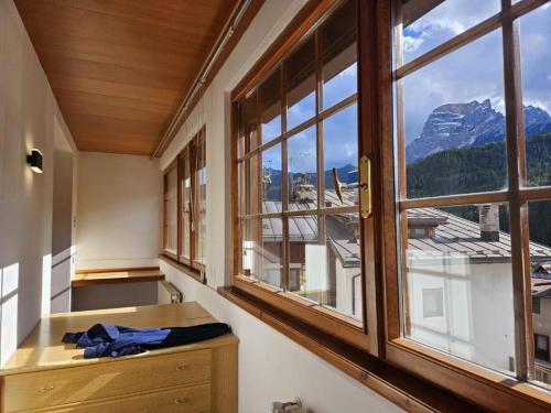 a room with windows with a view of a mountain at Best Western Hotel Nevada in San Vito di Cadore