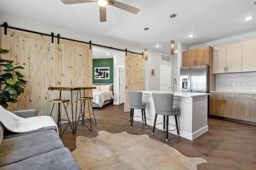 a kitchen and living room with a couch and a table at The Diamond Suite The Gulch in Nashville