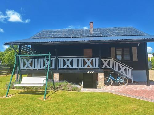 a house with a roof with solar panels on it at Domek w Dolinie Sanu in Witryłów