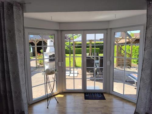 a sliding glass door with a view of a patio at Ferienhaus Dini, 25668 in Weener