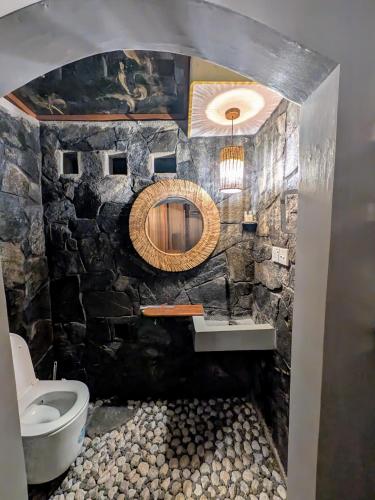 a stone bathroom with a sink and a mirror at Nomads Hideaway Near Matara Railway Station in Matara