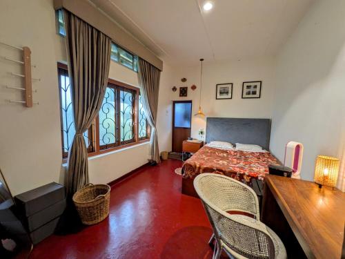 a bedroom with a bed and a table and chairs at Nomads Hideaway Near Matara Railway Station in Matara