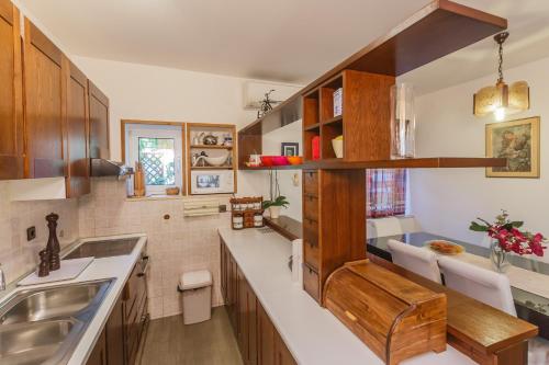 a kitchen with wooden cabinets and a sink at Apartments Ružić in Split