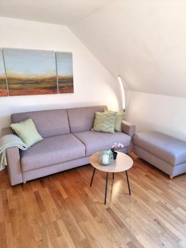 a living room with a couch and a table at Leo11 in Traunstein