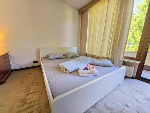 a bed in a room with a large window at Innsbruck Nature & City House I Free Parking in Innsbruck