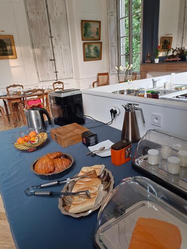 a blue counter top with bread and bags on it at Château de la Mothe in Olivet