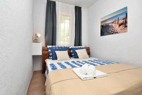 a bedroom with two beds with towels on them at House Velebit by the sea in Stinica