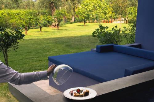 a person is holding a plate of food on a table at Hilton Sorrento Palace in Sorrento