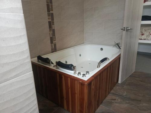 a large bath tub in a bathroom with a shower at CASA QUINTA BELLO HORIZONTE in La Mesa