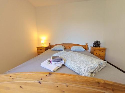 a bedroom with a wooden bed with towels on it at Innsbruck Nature & City House I Free Parking in Innsbruck