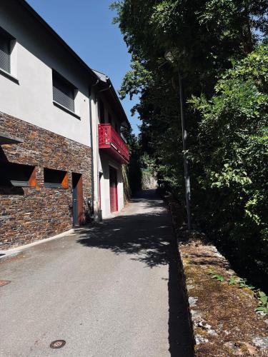 an empty street next to a brick building at Chalet du Parc in Ax-les-Thermes