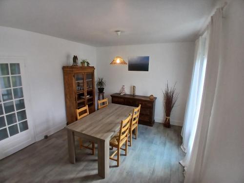 a dining room with a wooden table and chairs at Cocon cosy in Aix-les-Bains
