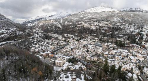 an aerial view of a city with snow covered mountains at Chalet du Parc in Ax-les-Thermes