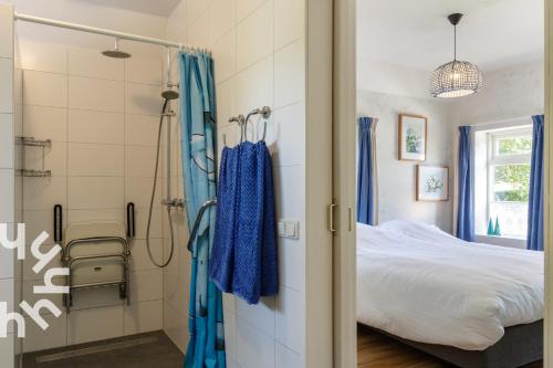 a bathroom with a shower and a bed in a room at OV517 - 6 persons holiday home De Kersenboomhoeve in Zuidveen