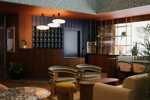 a restaurant with chairs and tables and wine bottles at Municipal Grand in Savannah