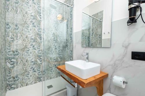 a bathroom with a sink and a shower at La Pineta nel Borgo in Ravenna