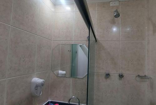 a bathroom with a shower with a mirror at Motel Casual in Santo André