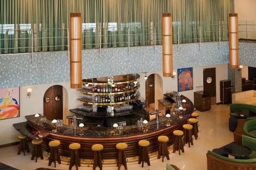 a lobby with a large circular table and chairs at Municipal Grand in Savannah