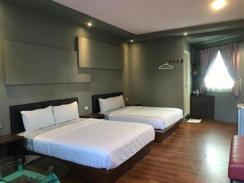 Postel nebo postele na pokoji v ubytování 墾丁貝殼灣旅店