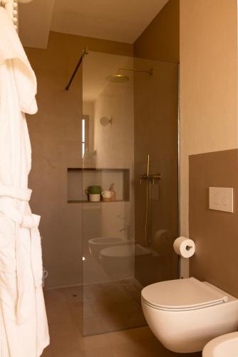 a bathroom with a toilet and a glass shower at Masseria Tarsia Morisco in Polignano a Mare