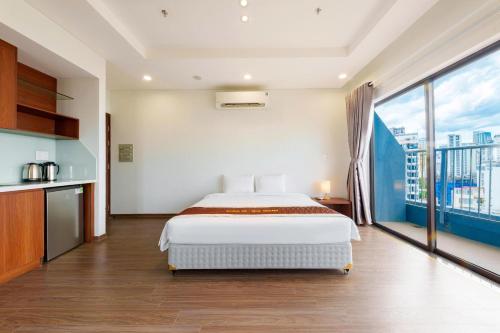 a bedroom with a bed and a large window at D26 Nha Trang Hotel in Nha Trang