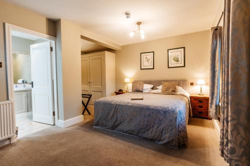 a bedroom with a large bed and a window at The Plough Inn & Restaurant in Congleton