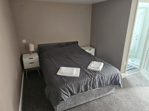 a bedroom with a bed with two towels on it at The Bulls Head Hotel in Youlgreave