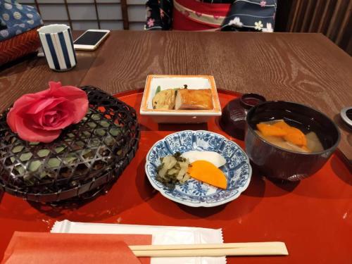 a table with a plate of food and a bowl of soup at 海雲 Kaiun Kawagoe リトル京都の和み宿 in Kawagoe