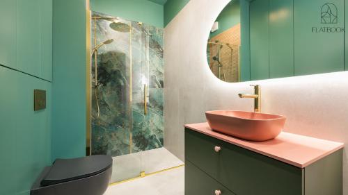 a bathroom with a sink and a shower at Flatbook - City Centre Granaria II & SPA in Gdańsk