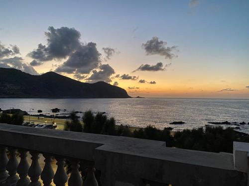 a view of the ocean at sunset from a balcony at Appartamento con vista mozzafiato a due passi dal centro in Favignana