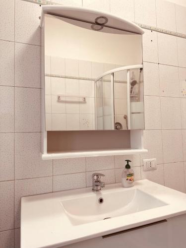 a bathroom with a sink and a mirror at Venice Cappucina Guest House in Mestre