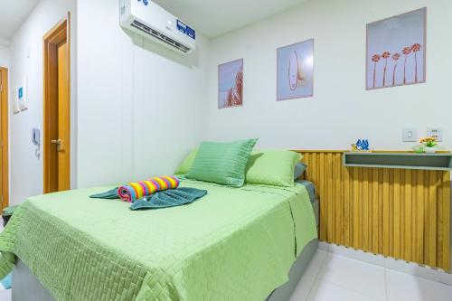 a bedroom with a green bed with a toy on it at Malia Beach #D14 - Apartamento por Carpediem in Cupe
