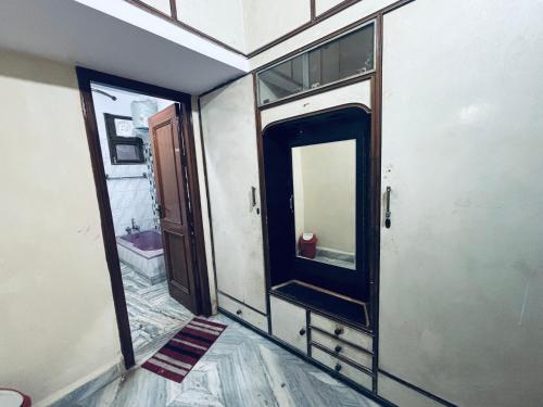 a bathroom with a mirror and a sink in it at Radha Madhavam Luxurious Boutique Stay in Mathura