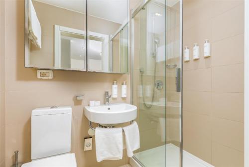 a bathroom with a sink and a shower at Park Plaza Verudela Pula in Pula