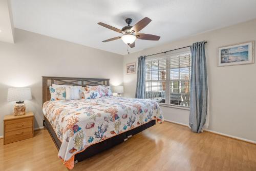 a bedroom with a bed and a ceiling fan at Little Slice in Cape Coral